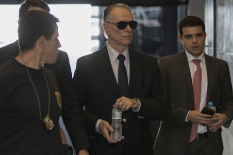 Carlos Nuzman, president of the Brazilian Olympic committee, arrives at Federal Police headquarters in Rio de Janeiro, Brazil, Tuesday, Sept. 5, 2017. Federal police searched Nuzman's house Tuesday morning. French and Brazilian authorities have been working on a corruption investigation involving bribery surrounding the awarding of the 2016 Rio Games and the 2020 Tokyo Games. (AP Photo/Leo Correa)