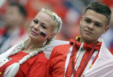 Russian supporters smile ahead of the group A match between Russia and Saudi Arabia which opens the 2018 soccer World Cup at the Luzhniki stadium in Moscow, Russia, Thursday, June 14, 2018. (AP Photo/Matthias Schrader)