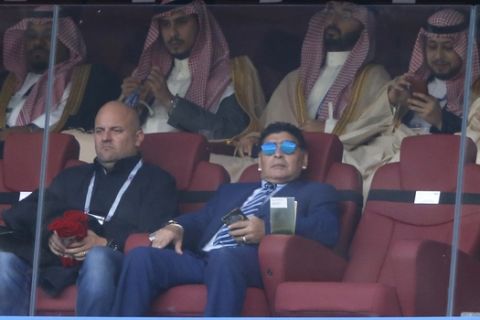 Argentina's former soccer star Diego Armando Maradona, with sunglasses, looks on ahead of the group A match between Russia and Saudi Arabia which opens the 2018 soccer World Cup at the Luzhniki stadium in Moscow, Russia, Thursday, June 14, 2018. (AP Photo/Hassan Ammar)