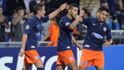 Montpellier's Moroccan midfielder Younes Belhanda (C) is congratuled by his teammates after scoring a goal during the UEFA Champions League football match Montpellier Herault SC versus Arsenal FC on September 18, 2012 at La Mosson stadium in Montpellier, southern France.  AFP PHOTO / PASCAL GUYOT        (Photo credit should read PASCAL GUYOT/AFP/GettyImages)