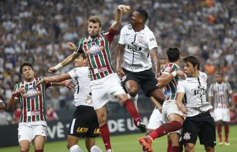Fluminense's Henrique, center left, and Corinthians' Jo, center right, fight for the ball during their Brasileirao championship soccer match in Sao Paulo, Brazil, Wednesday, Nov. 15, 2017. Corinthians won 3-1 and clenched the championship title. (AP Photo/Andre Penner)