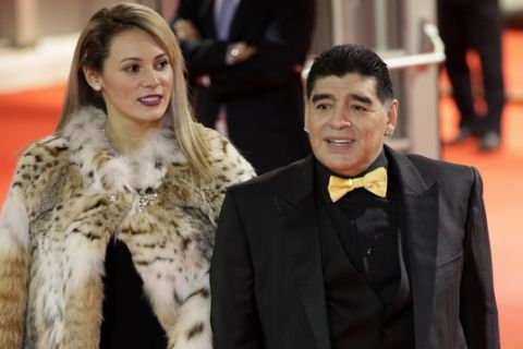 Argentinian soccer legend Diego Maradona and his girlfriend Rocio Oliva arrive for the 2018 soccer World Cup draw in the Kremlin in Moscow, Friday, Dec. 1, 2017. (AP Photo/Dmitri Lovetsky)
