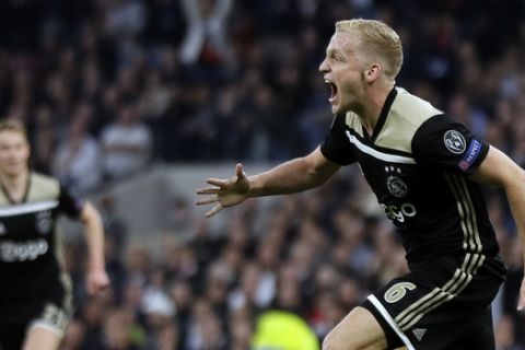 Ajax's Donny van de Beek celebrates after scoring his side's opening goal during the Champions League semifinal first leg soccer match between Tottenham Hotspur and Ajax at the Tottenham Hotspur stadium in London, Tuesday, April 30, 2019. (AP Photo/Kirsty Wigglesworth)
