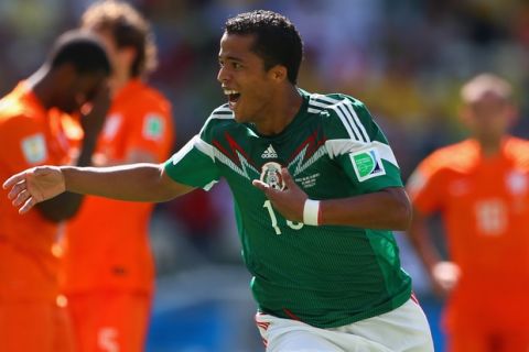 FORTALEZA, BRAZIL - JUNE 29:  Giovani dos Santos of Mexico celebrates scoring his team's first goal during the 2014 FIFA World Cup Brazil Round of 16 match between Netherlands and Mexico at Castelao on June 29, 2014 in Fortaleza, Brazil.  (Photo by Michael Steele/Getty Images)