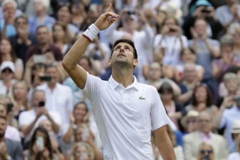 Serbia's Novak Djokovic celebrates defeating Switzerland's Roger Federer in the men's singles final match of the Wimbledon Tennis Championships in London, Sunday, July 14, 2019. (AP Photo/Kirsty Wigglesworth)