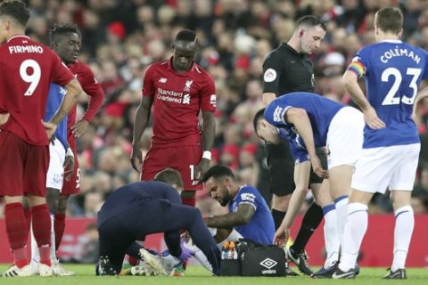 Everton forward Theo Walcott receives medical attention during the English Premier League soccer match between Liverpool and Everton at Anfield Stadium in Liverpool, England, Sunday, Dec. 2, 2018. (AP Photo/Jon Super)