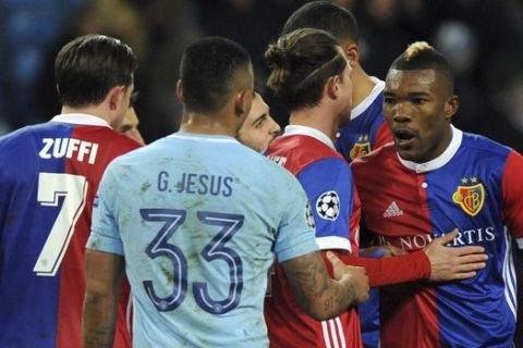 Basel's Geoffroy Serey Die, right, discusses with Manchester City's Gabriel Jesus at the end of the Champions League, round of 16, second leg soccer match between Manchester City and Basel at the Etihad Stadium in Manchester, England, Wednesday, March 7, 2018. The match finished 1-2. (AP Photo/Rui Vieira)