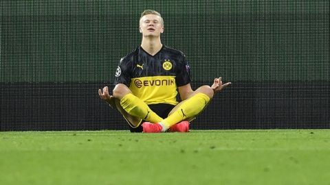 Dortmund's Erling Braut Haaland poses after scoring his first goal during the Champions League round of 16 first leg soccer match between Borussia Dortmund and Paris Saint Germain in Dortmund, Germany, Tuesday, Feb. 18, 2020. (AP Photo/Martin Meissner)