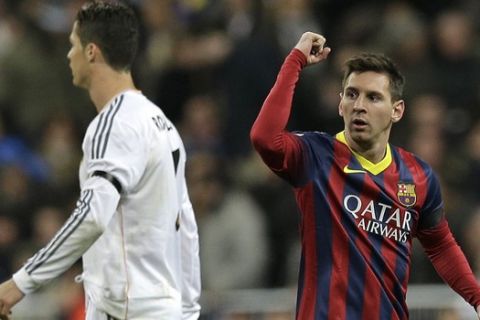 FC Barcelona's Lionel Messi from Argentina, right celebrates next to Real Madrid's Cristiano Ronaldo after scoring his team's 2nd goal during a Spanish La Liga soccer match at the Santiago Bernabeu stadium in Madrid, Sunday March 23, 2014. (AP Photo/Paul White)