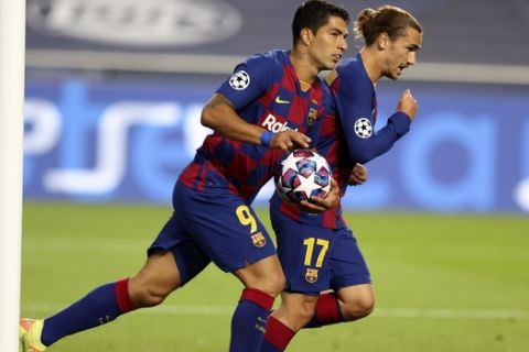 Barcelona's Luis Suarez, left, celebrates with Barcelona's Antoine Griezmann after scoring a goal during the Champions League quarterfinal soccer match between Barcelona and Bayern Munich in Lisbon, Portugal, Friday, Aug. 14, 2020. (Rafael Marchante/Pool via AP)