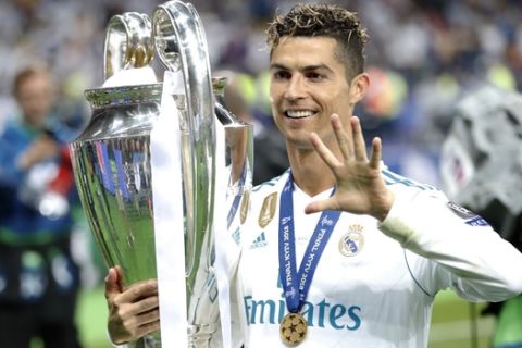 Real Madrid's Cristiano Ronaldo celebrates with the trophy after winning the Champions League Final soccer match between Real Madrid and Liverpool at the Olimpiyskiy Stadium in Kiev, Ukraine, Saturday, May 26, 2018. (AP Photo/Pavel Golovkin)