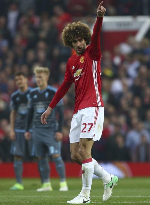 Manchester United's Marouane Fellaini celebrates after scoring the opening goal of the game during the Europa League semifinal second leg soccer match between Manchester United and Celta Vigo at Old Trafford in Manchester, England, Thursday, May 11, 2017. (AP Photo/Dave Thompson)