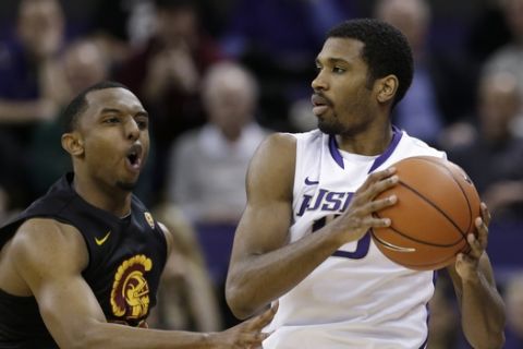 Washington's Scott Suggs looks to pass as Southern California's Byron Wesley defends in the second half of an NCAA college basketball game Wednesday, March 6, 2013, in Seattle. Washington won 65-57. (AP Photo/Elaine Thompson)