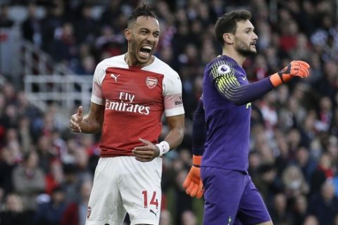 Arsenal's Pierre-Emerick Aubameyang, left, reacts after a missed scoring opportunity during the English Premier League soccer match between Arsenal and Tottenham Hotspur at the Emirates Stadium in London, Sunday Dec. 2, 2018. (AP Photo/Tim Ireland)