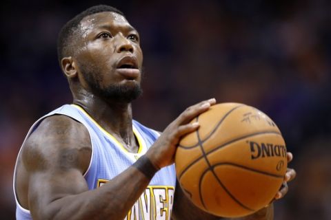 Denver Nuggets' Nate Robinson shoots a foul shot during the first half of an NBA basketball game against the Phoenix Suns Wednesday, Nov. 26, 2014, in Phoenix. (AP Photo/Ross D. Franklin) 