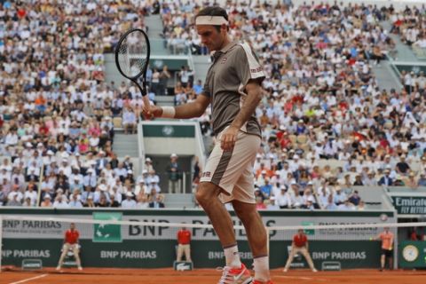 Switzerland's Roger Federer reacts after missing a shot against Switzerland's Stan Wawrinka during their quarterfinal match of the French Open tennis tournament at the Roland Garros stadium in Paris, Tuesday, June 4, 2019. (AP Photo/Michel Euler)
