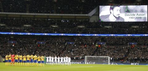 Players stand during a minute of silence for Fiorentina player Davide Astori who died last Sunday, prior to the start the Champions League, round of 16, second-leg soccer match between Juventus and Tottenham Hotspur, at the Wembley Stadium in London, Wednesday, March 7, 2018. (AP Photo/Frank Augstein)