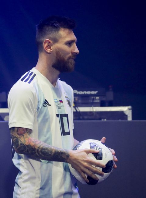 Argentinian national soccer team striker Lionel Messi poses with the official match ball for the 2018 FIFA World Cup Russia, named Telstar 18 , during the unveiling ceremony in Moscow, Russia, Thursday, Nov. 9, 2017. The Telstar 18 has a retro black-and-white design harking back to the original Adidas Telstar ball used for the 1970 World Cup, and Adidas says that in terms of structure, it's an evolution of the ball used for the last World Cup in 2014. (Oleg Shalmer)