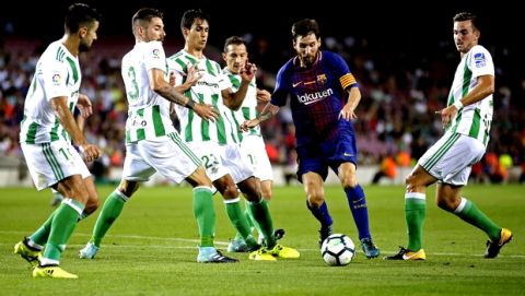 FC Barcelona's Lionel Messi, second right, in action during the Spanish La Liga soccer match between FC Barcelona and Betis at the Camp Nou stadium in Barcelona, Spain, Sunday, Aug. 20, 2017. (AP Photo/Manu Fernandez)