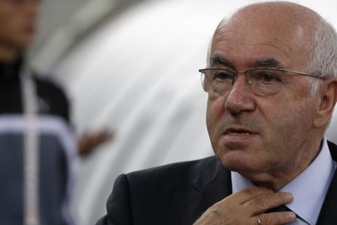 In this photo taken on Thursday, Sept. 4, 2014, Paolo Tavecchio adjusts his tie prior to a friendly soccer match between Italy and The Netherlands in Bari, Italy. UEFA has banned Italian soccer federation president Carlo Tavecchio for six months following a racist comment during his electoral campaign. Tavecchio, a long-standing executive in Italian football, was elected president in August despite causing a stir over a reference to bananas when discussing the presence of foreign players in Italy. (AP Photo/Gregorio Borgia)