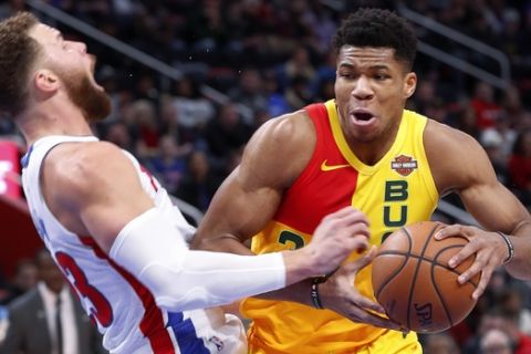 Milwaukee Bucks forward Giannis Antetokounmpo (34) charges into Detroit Pistons forward Blake Griffin (23) in the first half of an NBA basketball game in Detroit, Monday, Dec. 17, 2018. (AP Photo/Paul Sancya)