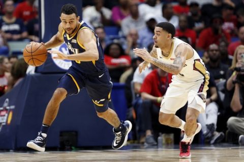 Utah Jazz guard Nigel Williams-Goss (0) drives past New Orleans Pelicans guard Josh Gray (5) in the second half of a preseason NBA basketball game in New Orleans, Friday, Oct. 11, 2019. The Pelicans won 128-127. (AP Photo/Tyler Kaufman)