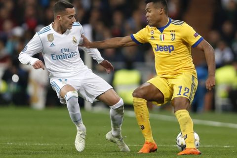 Real Madrid's Lucas Vazquez fights for the ball against Juventus' Alex Sandro during a Champions League quarter final second leg soccer match between Real Madrid and Juventus at the Santiago Bernabeu stadium in Madrid, Wednesday, April 11, 2018. (AP Photo/Francisco Seco)