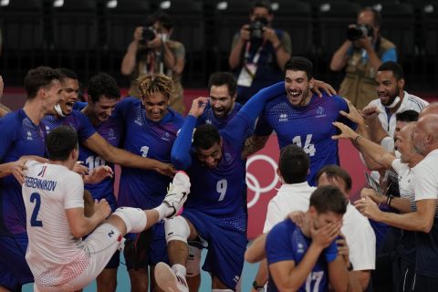 Team France celebrate winning the men's volleyball gold medal match against the Russian Olympic Committee, at the 2020 Summer Olympics, Saturday, Aug. 7, 2021, in Tokyo, Japan. (AP Photo/Frank Augstein)