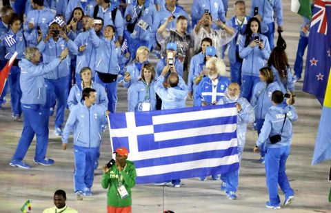 Athletes from Greece carry their flag into the closing ceremony in the Maracana stadium at the 2016 Summer Olympics in Rio de Janeiro, Brazil, Sunday, Aug. 21, 2016. (AP Photo/Charlie Riedel)
