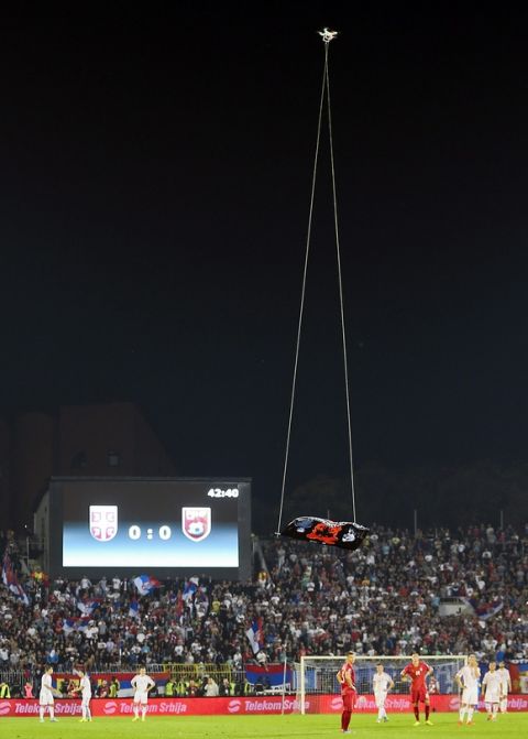 epaselect epa04447055 A flag with Albanian symbols flies over the stadium remote controlled by a drone during the Euro 2016 Group I qualifying match between Serbia and Albania which provoked a fight between players, at the Partizan stadium in Belgrade, Serbia, 14 October 2014. The match was suspended.  EPA/SRDJAN SUKI