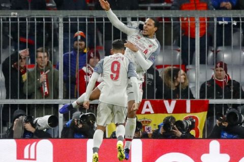 Liverpool defender Virgil Van Dijk, right, celebrates after scoring his side's second goal during the Champions League round of 16 second leg soccer match between Bayern Munich and Liverpool in Munich, Germany, Wednesday, March 13, 2019. (AP Photo/Matthias Schrader)