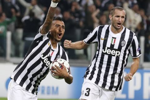 Juventus midfielder Arturo Vidal, left, of Chile, left, celebrates with his teammate Giorgio Chiellini after scoring, during a Champions League, Group B, soccer match between Juventus and Galatasaray at the Juventus stadium in Turin, Italy, Wednesday, Oct. 2, 2013. (AP Photo/Antonio Calanni)