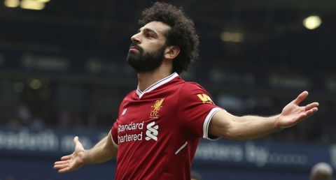 Liverpool's Mohamed Salah celebrates scoring his side's second goal of the game, during the English Premier League soccer match between West Bromwich Albion and Liverpool, at The Hawthorns, West Bromwich, England, Saturday April 21, 2018. (Nigel French/PA via AP)