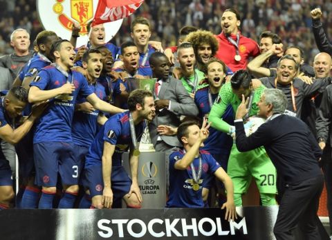 United manager Jose Mourinho, foreground right, gestures to the players celebrating after winning the soccer Europa League final between Ajax Amsterdam and Manchester United at the Friends Arena in Stockholm, Sweden, Wednesday, May 24, 2017. United won 2-0. (AP Photo/Martin Meissner)