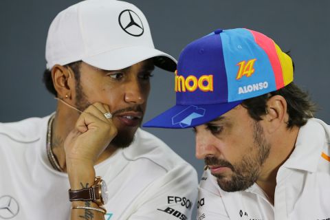 Mclaren driver Fernando Alonso of Spain, right, listens to Mercedes driver Lewis Hamilton of Britain during a news conference at the Yas Marina racetrack in Abu Dhabi, United Arab Emirates, Thursday, Nov. 22, 2018. The Emirates Formula One Grand Prix will take place on Sunday. (AP Photo/Kamran Jebreili)
