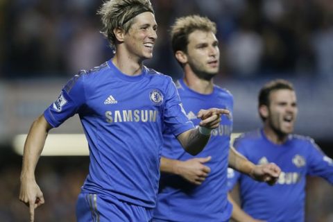 Chelsea's Fernando Torres, left, celebrates scoring a goal with Branislav Ivanovic, center, and Juan Mata during the English Premier League soccer match between Chelsea and Reading at Stamford Bridge Stadium in London, Wednesday,Aug. 22, 2012. (AP Photo/Kirsty Wigglesworth) 