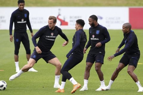 England's Harry Kane, left, controls the ball during a training session at St George's Park, in Burton, England,  Monday May 28, 2018. England will play Nigeria in an international friendly match on Saturday. (Nick Potts/PA  via AP)