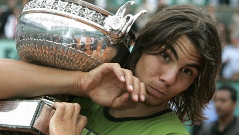 Spain's Rafael Nadal holds the trophy after defeating Argentina's Mariano Puerta in their final match of the French Open tennis tournament, at the Roland Garros stadium, Sunday June 5, 2005 in Paris. Nadal won 6-7 (6), 6-3, 6-1, 7-5. (AP Photo/Michel Euler)