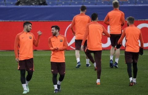 Barcelona's Luis Suarez, left, talks with his teammate Lionel Messi during a training session at Rome's Olympic Stadium, Monday, April 9, 2018, on the eve of the Champions League quarter final second leg soccer match against Roma. (AP Photo/Gregorio Borgia)