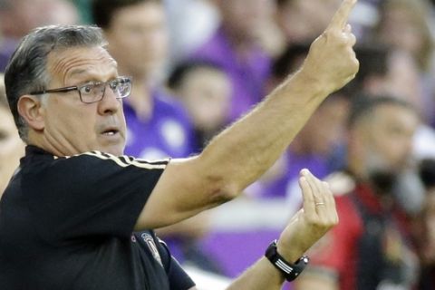 Atlanta United head coach Gerardo Martino gesture to his players during the first half of an MLS soccer match, Friday, July 21, 2017, in Orlando, Fla. (AP Photo/John Raoux)