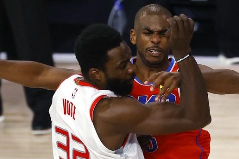 Oklahoma City Thunder's Chris Paul, right, tangles with Houston Rockets' Jeff Green during the third quarter of Game 3 of an NBA basketball first-round playoff series, Saturday, Aug. 22, 2020, in Lake Buena Vista, Fla. (Mike Ehrmann/Pool Photo via AP)