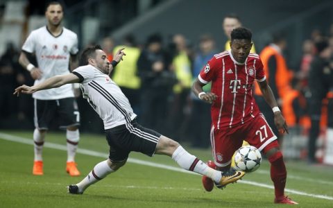 Bayern's David Alaba, right, controls the ball as Besiktas' player tries to stop him during the Champions League, round of 16, second leg, soccer match between Besiktas and Bayern Munich at Vodafone Arena stadium in Istanbul, Wednesday, March 14, 2018. (AP Photo/Lefteris Pitarakis)