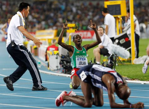 Ethiopia's Ibrahim Jeilan, center back, celebrates after winning gold ahead of Britain's Mo Farah, front, following the Men's 10,000m at the World Athletics Championships in Daegu, South Korea, Sunday, Aug. 28, 2011.(AP Photo/Anja Niedringhaus)