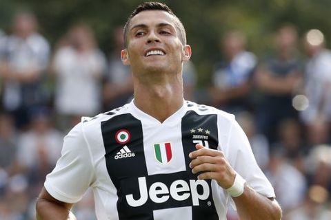 Juventus' Cristiano Ronaldo smiles during a friendly soccer match between the Juventus A and B teams, in Villar Perosa, near Turin, Italy, Sunday, Aug.12, 2018. (AP Photo/Antonio Calanni)