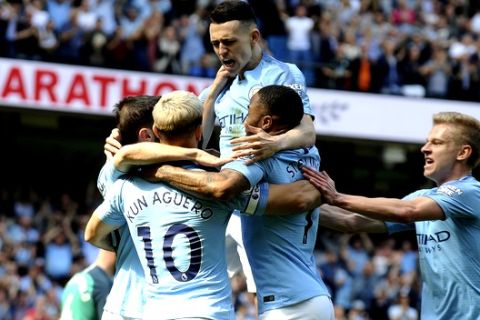 Manchester City's Phill Foden, center top, celebrates his goal against Tottenham with his teammates during the English Premier League soccer match between Manchester City and Tottenham Hotspur at Etihad stadium in Manchester, England, Saturday, April 20, 2019. (AP Photo/Rui Vieira)