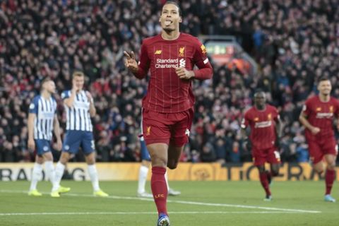 Liverpool's Virgil van Dijk celebrates after scoring his second goal during the English Premier League soccer match between Liverpool and Brighton at Anfield Stadium, Liverpool, England, Saturday, Nov. 30, 2019. (AP Photo/Jon Super)