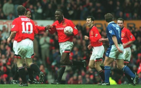 4 MAR 1995:  ANDY COLE OF MANCHESTER UNITED IS CONGRATULATED BY HIS TEAM MATES AFTER HE SCORES HIS SECOND GOAL FOR MAN UTD DURING THEIR 9-0 VICTORY OVER IPSWICH TOWN IN THE FA PREMIERSHIP MATCH AT OLD TRAFFORD, MANCHESTER. Mandatory Credit: Anton Want/ALLSPORT