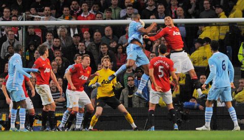 Manchester City's Belgian footballer Vincent Kompany (4th R) scores his team's first goal against Manchester United during their English Premier League match at The Etihad Stadium in Manchester, north-west England, on April 30, 2012. AFP PHOTO/ANDREW YATES
 - RESTRICTED TO EDITORIAL USE. No use with unauthorized audio, video, data, fixture lists, club/league logos or live services. Online in-match use limited to 45 images, no video emulation. No use in betting, games or single club/league/player publicationsANDREW YATES/AFP/GettyImages