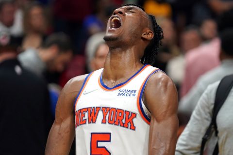 New York Knicks guard Immanuel Quickley (5) lets out a scream after his team defeated the Miami Heat 111-103 in  an NBA basketball game, Friday, March 25, 2022, in Miami. (AP Photo/Jim Rassol)