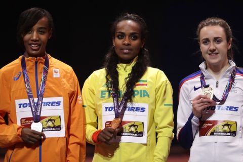 Ethiopia's gold medal winner Genzebe Dibaba is flanked by Netherlands' silver medal winner Sifan Hassan, left, and Britain's bronze medal winner Laura Muir during the ceremony for the women's 3000-meter final at the World Athletics Indoor Championships in Birmingham, Britain, Thursday, March 1, 2018. (AP Photo/Matt Dunham)